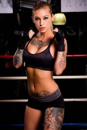 Tattooed MILF pornstar Kleio Valentien in shorts showing big tits in gym on chickinfo.com