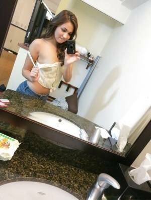 Sassy brunette stripping in front of the mirror and making selfies on chickinfo.com