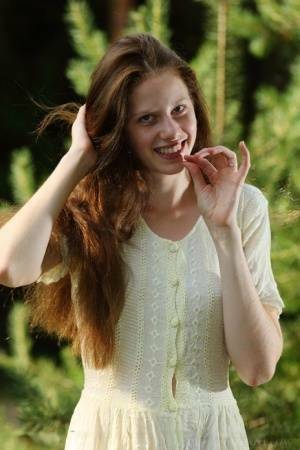 Pale girl with long red hair Nicole K gets totally naked amid saplings on chickinfo.com