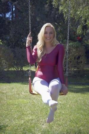 Busty blonde Hayley Marie Coppin strips bodysuit and white pantyhose outdoors on chickinfo.com