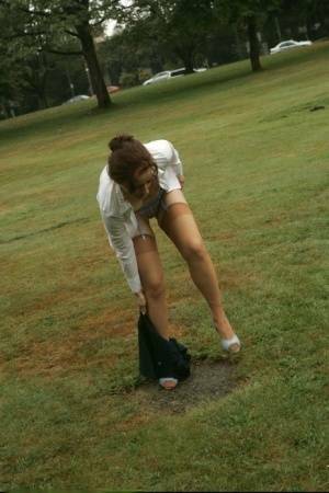 Amateur chick Dirty Angie strips to her pretties and tan nylons in a park on chickinfo.com