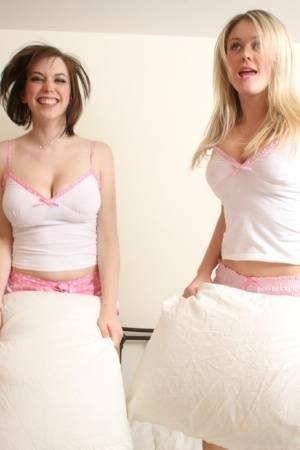 Young blonde Brooke Little and a girlfriend expose their big naturals on a bed on chickinfo.com