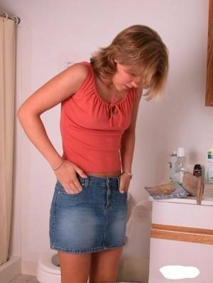 Amateur girl Karen hikes her denim skirt in the bathroom to expose her panties on chickinfo.com