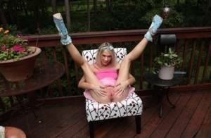 Thin blonde Sky Pierce attaches clamps to her wide open pussy on a deck on chickinfo.com