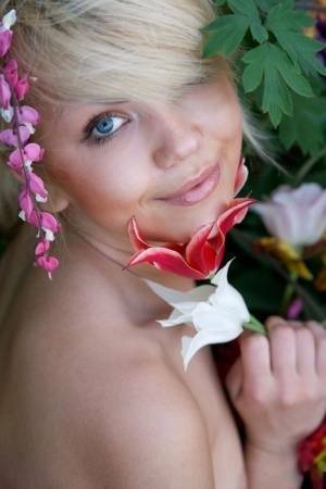 Cute young blonde Iveta poses in the nude while in a garden on chickinfo.com