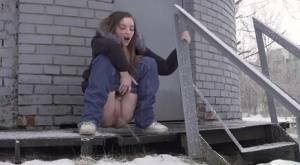 White girl pulls down her jeans to pee in the snow behind a building on chickinfo.com