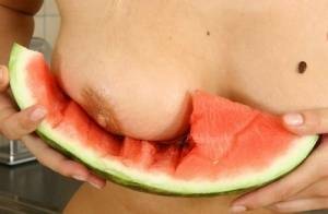 Blonde vixen Flower undressing in the kitchen to eat melon with bare big tits on chickinfo.com
