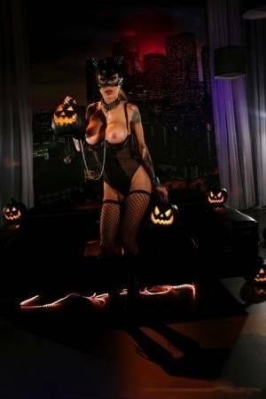 Tattooed chick Sarah Jessie exposes her tits and twat in a Catwoman mask on chickinfo.com
