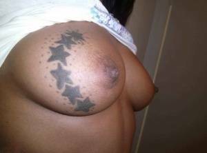 Ebony amateur takes self shots of her big tattooed boobs and bald vagina on chickinfo.com