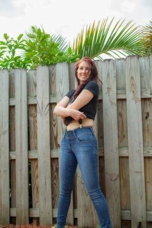 Hot redhead Andy Adams loses her t-shirt & jeans in the yard to pose naked on chickinfo.com