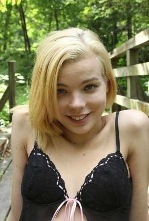 Cute teen amateur Sophia Kitten posing in nude in knee high socks in woods on chickinfo.com