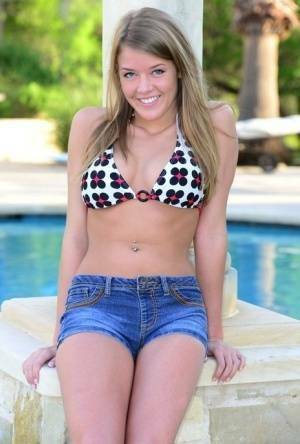 Cute teen Sophia Wood drops her shorts by the pool to toy with a vibrator on chickinfo.com