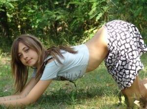 Shapely young teen in tiny t-shirt and short skirt posing outdoors on chickinfo.com