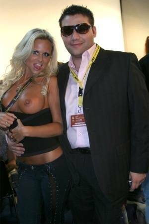 Blonde MILF Silvia Saint fully clothed posing & flaunting big tits at party on chickinfo.com