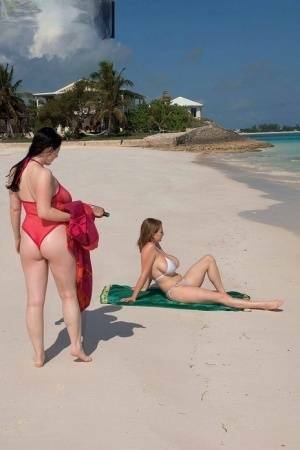 Busty lesbian girls let their huge knockers loose to kiss & lick on the beach on chickinfo.com