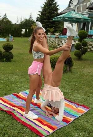 Young lesbians Eveline Dellai & Katy Rose fist pussies during sex on a lawn on chickinfo.com