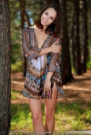 Sweet teen with an ass to die for disrobes for great nude poses in a forest on chickinfo.com