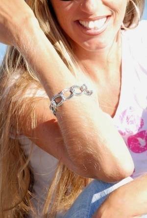 Amateur model Lori Anderson shows off her hairy arms while fully clothed on chickinfo.com