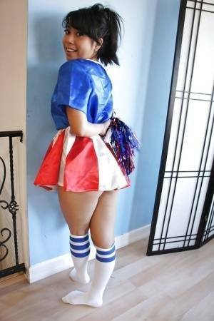 Tiny Asian cheerleader May Lee posing in cute uniform and socks on chickinfo.com
