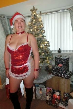 Busty blonde Barby masturbates her shaved pussy near the Christmas tree on chickinfo.com