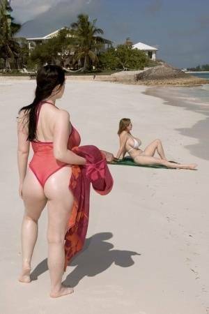Plump female Christy Mark and her big boobed friend have lesbian sex on beach on chickinfo.com