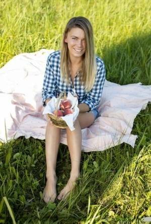 Nice teen Paulina gets completely naked on a blanket in a field on chickinfo.com