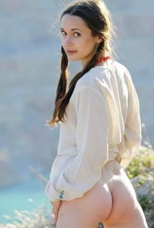 Teen model Ilona B poses nude in pigtails high above ocean waters on chickinfo.com