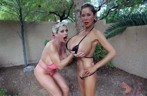 Big titted older women Claudia Marie and Minka kiss outdoors in skimpy bikinis on chickinfo.com