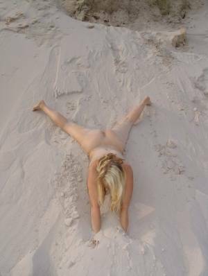 Blonde amateur Sweet Susi gets totally naked on a sandy bank by herself on chickinfo.com