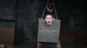 Blonde girl Odette Delacroix is made to suck a black cock with head in stocks on chickinfo.com