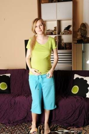 Smiley pregnant amateur with puffy nipples and hairy gash getting naked on chickinfo.com