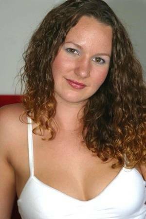 Amateur chick with wavy hair and a phat ass finger spreads her pussy on a sofa on chickinfo.com