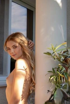 Young blonde Chanel Fenn shows her sexy ass while getting naked in a garden on chickinfo.com