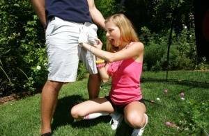 Young blonde girl Nicole Ray giving large dick oral sex outdoors on lawn on chickinfo.com