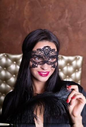 Sexy brunette Leyla Lee removes a mask and robes to pose nude with a feather on chickinfo.com