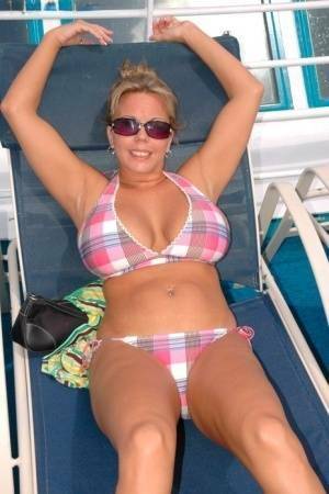 Hugely busty Amber Lynn Bach doffs her bikini to spread her legs wide nude on chickinfo.com