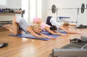 Young girls stretch out on yoga mats before commencing a lesbian threesome on chickinfo.com