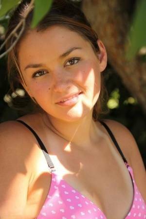 Petite amateur Allie Haze shows her tan lined body in the shade of a tree on chickinfo.com
