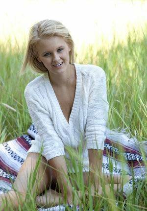 Blue eyed blonde teen Marie casts off her clothes to pose nude in a field on chickinfo.com