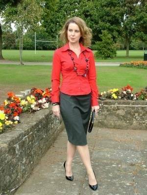 Fully clothed woman steps out of a stiletto heel while visiting a public park on chickinfo.com