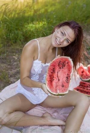 Sweet young girl gets naked while eating a watermelon under a tree on chickinfo.com