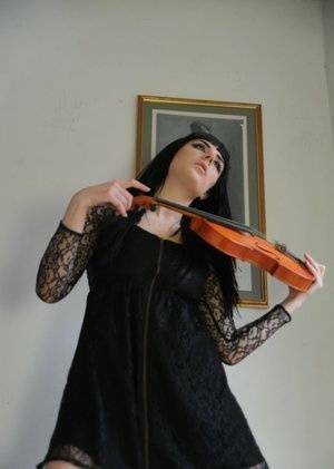Dark haired violin player Sam Bentley strikes great poses while getting naked on chickinfo.com