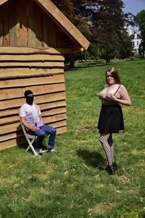 Natural redhead masturbates on a lawn before teasing a masked man on chickinfo.com
