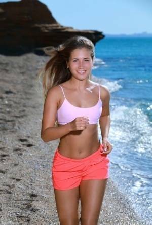 Fit young girl Mary Rock gets completely naked on a beach after exercising on chickinfo.com