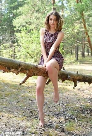Nice young girl Ari gets completely naked while in a forested area on chickinfo.com