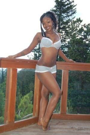 Black girl Amber uncups her big tits while getting in an outdoor hot tub on chickinfo.com